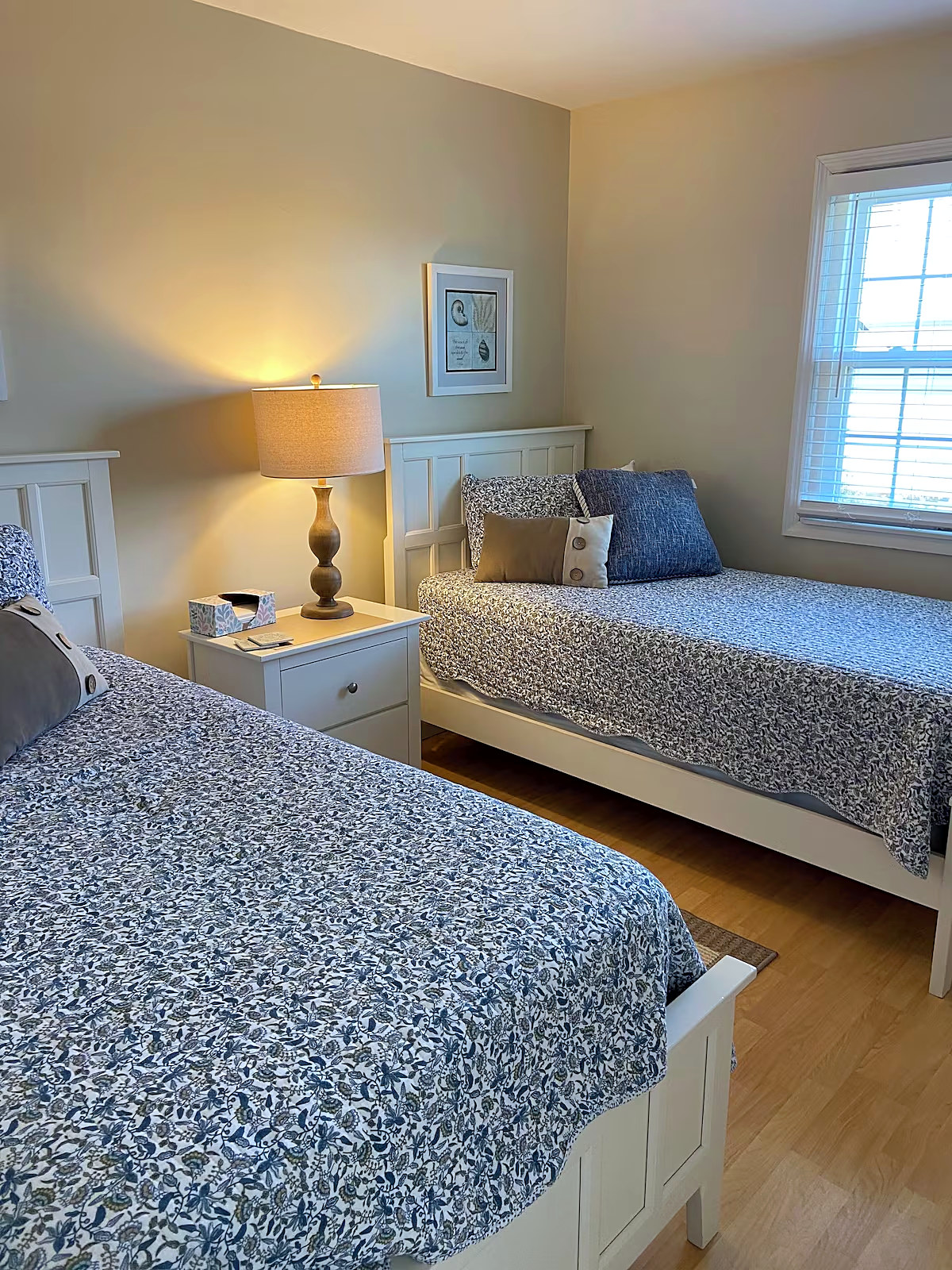 Bedroom with two twin beds in blue patterned quilts